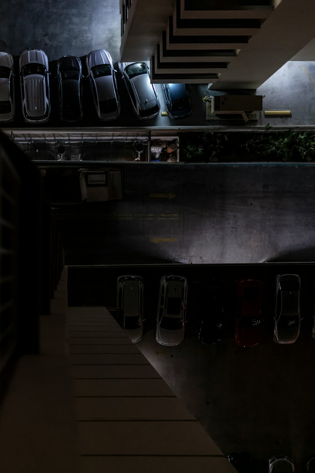 Atmospheric interior of a hidden private automobile collection with dramatic lighting