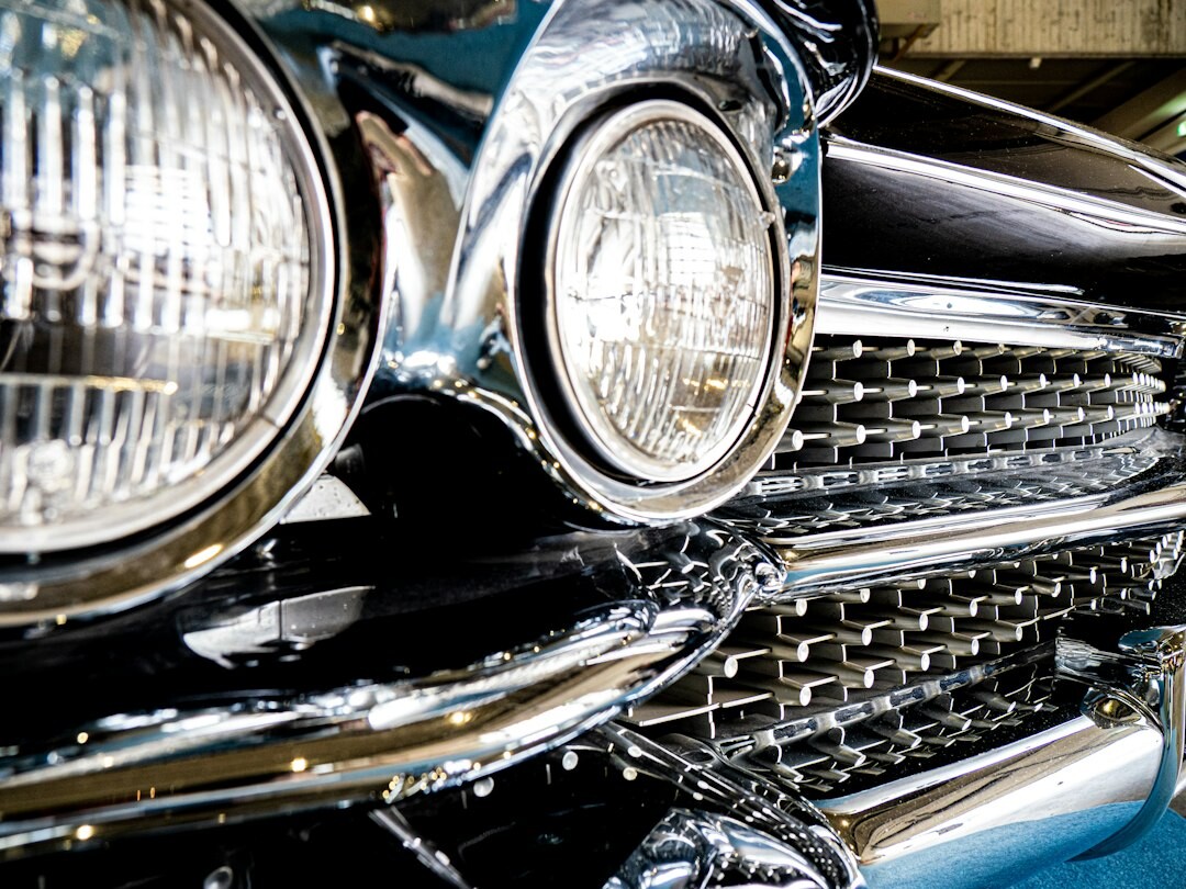 Close up of a vintage automobile chrome grille and headlight detail